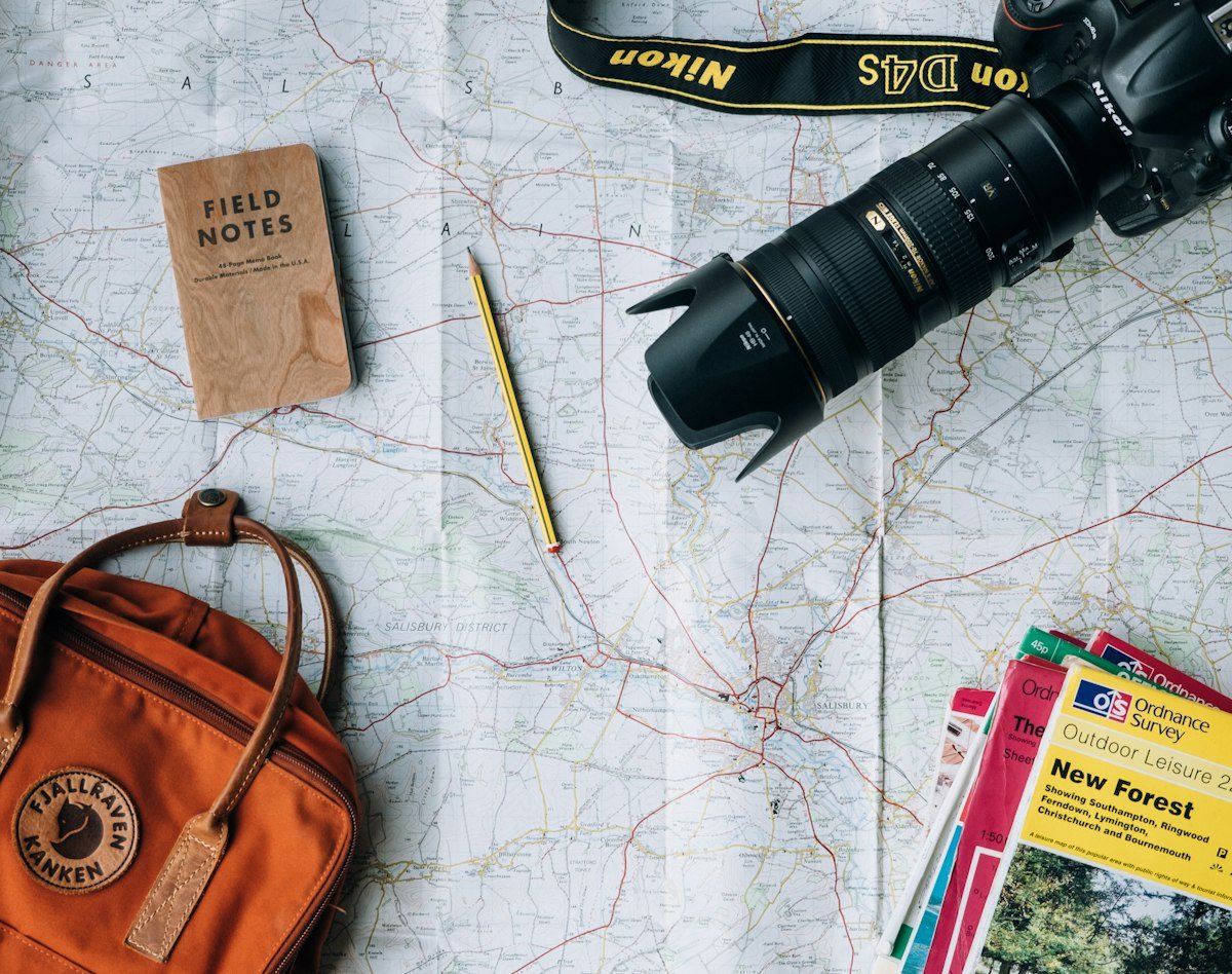 UK Ordnance Survey maps and travel planning kit, representing the paperwork behind package holidays and financial protection rules