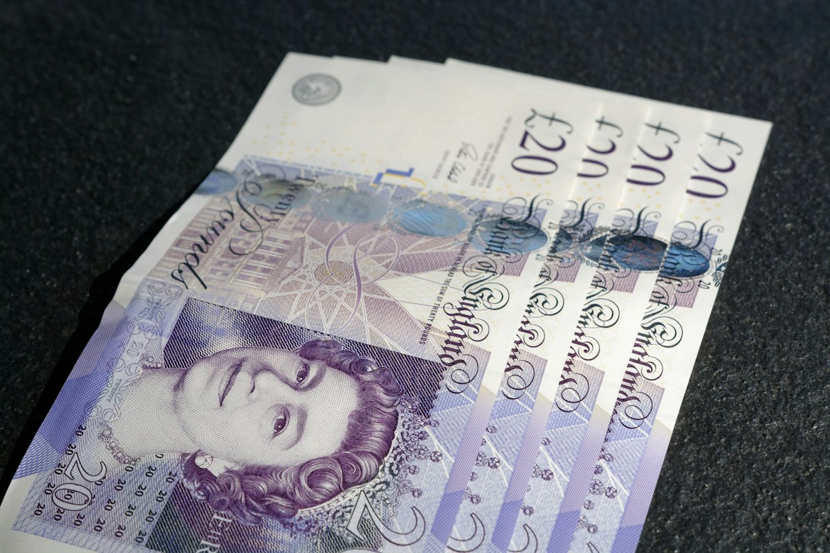 Bank of England £20 notes, representing a travel website budget in pounds sterling