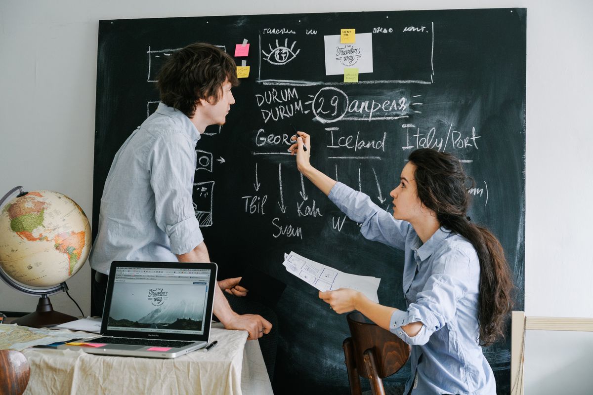 Couple planning a trip itinerary, the kind of customer a UK travel agency budgets its website around